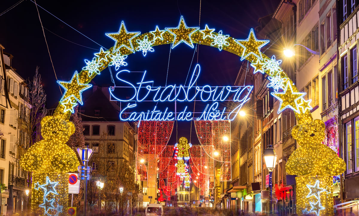 The enchanting streets of Strasbourg, France, illuminated with festive Christmas lights and adorned with intricate decorations, a must-visit destination for luxury Christmas travel to European Christmas markets.