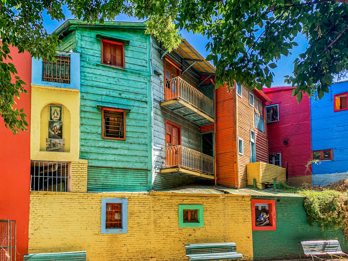 Colorful houses line El Caminito in Buenos Aires' La Boca district, a vibrant destination for cultural experiences and bespoke travel.