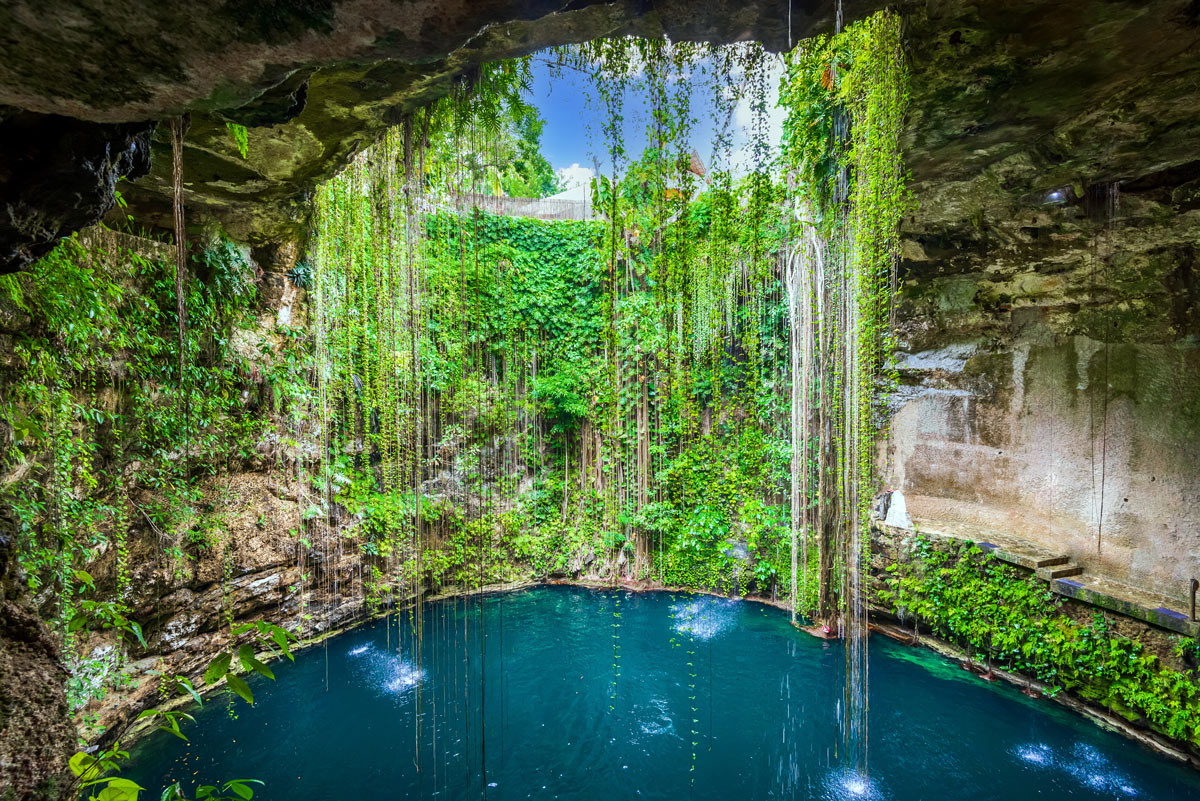 Ik-Kil Cenote in Riviera Maya, Mexico, offers a stunning natural retreat with crystal-clear waters, ideal for exclusive adventures and luxury exploration.